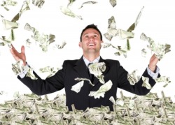 Businessman standing in a pile of money throwing it up into the air