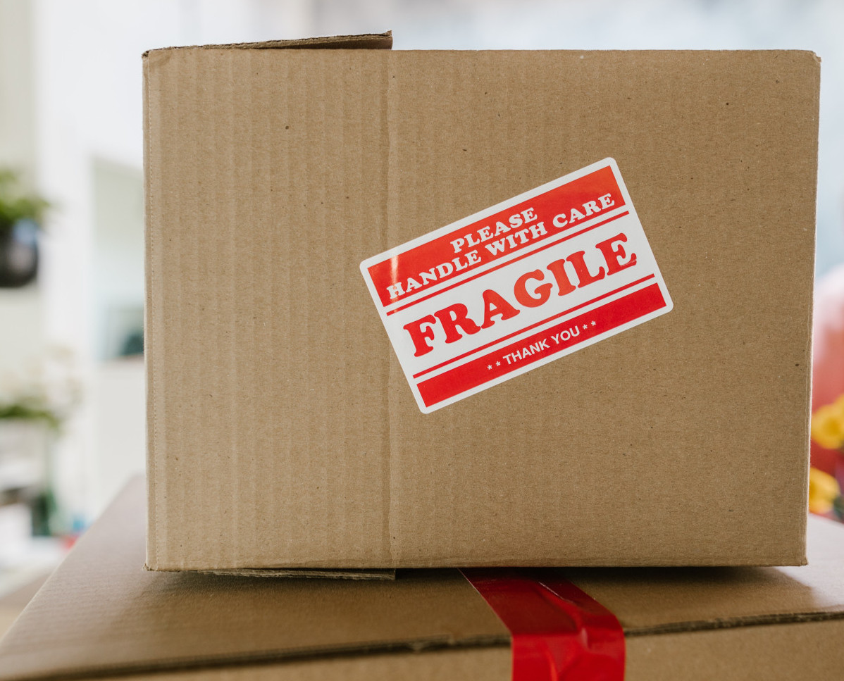 A cardboard box with a Fragile sticker on it