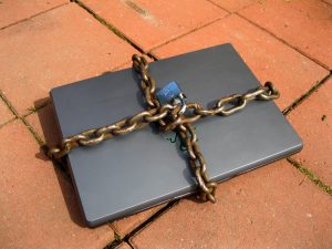 Laptop with chains and a lock around it