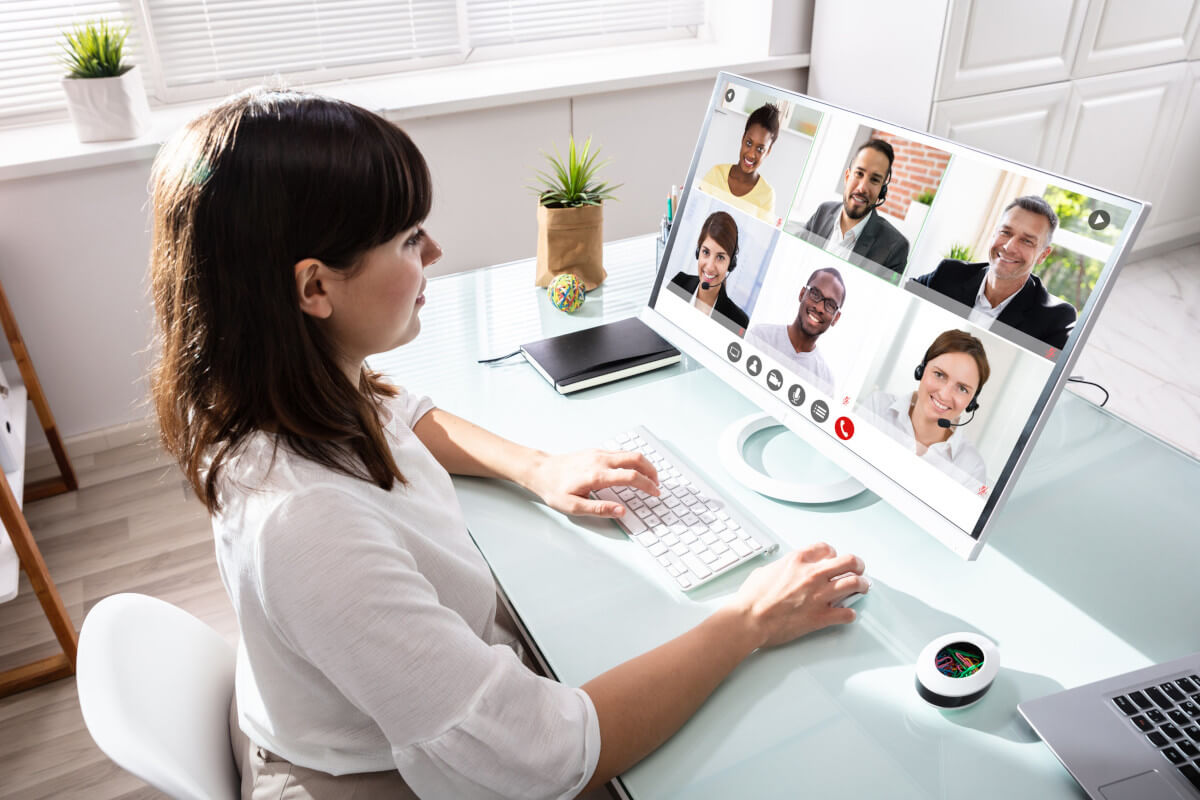 Woman on video conferencing call with six team members